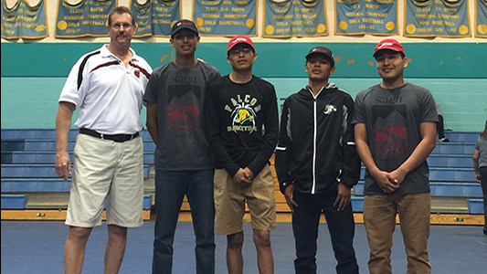 Coach Tom Kuyper (far left) stands with the four Alchesay High Seniors who signed